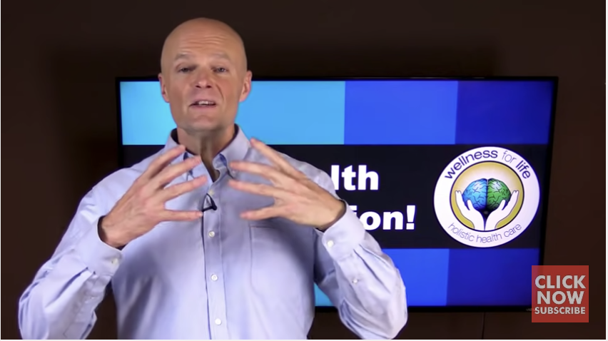 A man in a collared shirt presents a speech for Wellness for Life - Holistic Health Care.